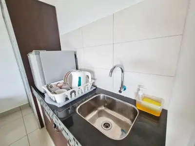 a kitchen counter with a sink in a kitchen at Marina Teluk Batik by Manhattan Group in Lumut