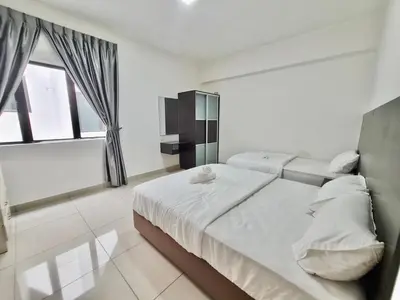 a white bedroom with two beds and a window at Marina Teluk Batik by Manhattan Group in Lumut