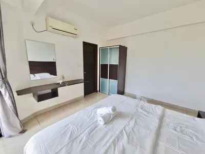 a white bed in a room with a sink at Marina Teluk Batik by Manhattan Group in Lumut