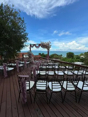 a bunch of tables and chairs on a deck at VELAMUNDi INN Batu Ferringhi in Batu Ferringhi