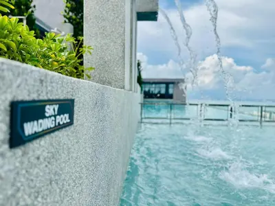 a sign on a wall next to a swimming pool at Sky Pool Luxury Stay Sea View Bayan Airport in Bayan Lepas