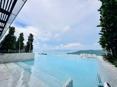 a swimming pool with a view of the water at Sky Pool Luxury Stay Sea View Bayan Airport in Bayan Lepas