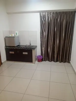 a kitchen with a counter and a curtain in a room at Marina sunset view in Lumut
