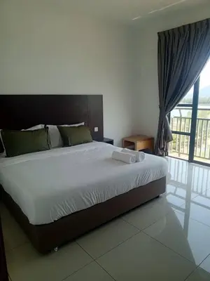 a bedroom with a large bed with a large window at Marina sunset view in Lumut