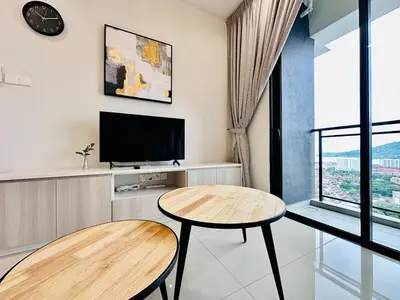a living room with two tables and a tv at CozyStay Rooftop Sky Pool Sea &Bridge View Luxury 9pax in Bayan Lepas