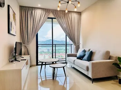a living room with a couch and a large window at CozyStay Rooftop Sky Pool Sea &Bridge View Luxury 9pax in Bayan Lepas