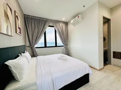 a bedroom with a white bed and a window at CozyStay Rooftop Sky Pool Sea &Bridge View Luxury 9pax in Bayan Lepas
