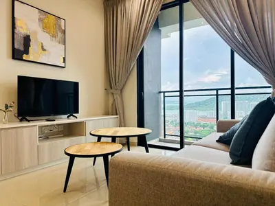 a living room with a couch and a tv at New LuxurySuite Rooftop Pool Stunning View airport 9pax in Bayan Lepas
