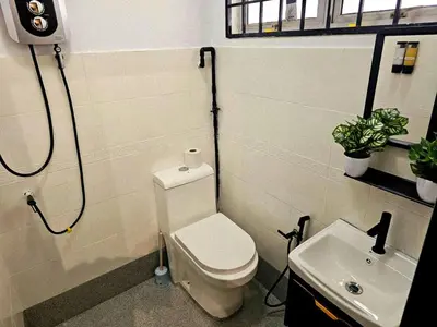 a bathroom with a toilet and a sink at Blue House Kampar 3BR Family Suite-Kids Playroom Near UTAR in Kampar