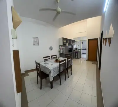a kitchen and dining room with a table and chairs at Homestay Dmickey in Sungai Petani
