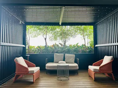 a room with two chairs and a table and a window at Luxe Seaview Rooftop Pool Airport bayan lepas in Bayan Lepas