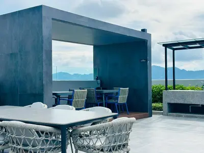 a patio with a table and chairs with a view at Luxe Seaview Rooftop Pool Airport bayan lepas in Bayan Lepas