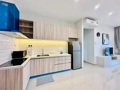 a kitchen with a sink and a refrigerator at Luxe Seaview Rooftop Pool Airport bayan lepas in Bayan Lepas