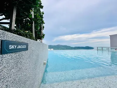 a sign on a wall next to a body of water at Sea Bridge View Sky Pool Cozy 3BR Retreat airport 9pax in Bayan Lepas