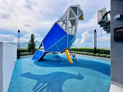 a blue slide on top of a swimming pool at Sea Bridge View Sky Pool Cozy 3BR Retreat airport 9pax in Bayan Lepas