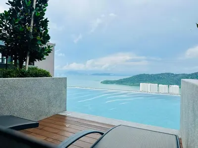 a swimming pool with a view of the ocean at Sea Bridge View Sky Pool Cozy 3BR Retreat airport 9pax in Bayan Lepas