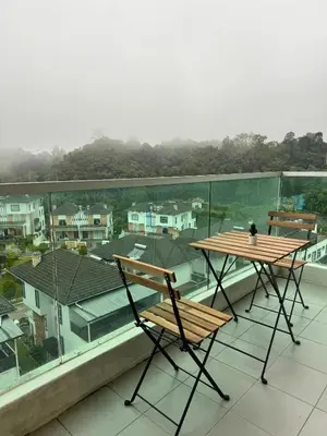 a table and chairs sitting on a roof at AYAAN Nova PingPong House Free Parking in Tanah Rata
