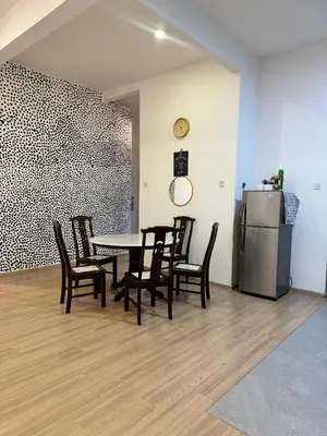 a dining room with a table and chairs and a refrigerator at AYAAN Nova PingPong House Free Parking in Tanah Rata