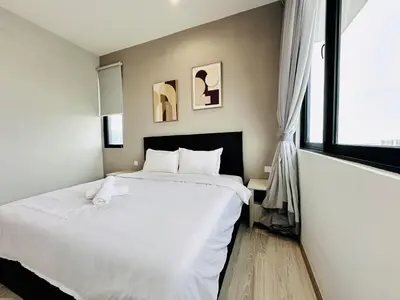 a bedroom with a large white bed and a window at Iconic Regency bayan lepas 42 skypool airport usm 9pax in Bayan Lepas