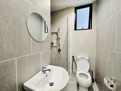 a bathroom with a toilet and a sink and a mirror at Iconic Regency bayan lepas 42 skypool airport usm 9pax in Bayan Lepas