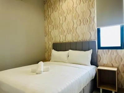 a bedroom with a bed with a towel on it at Iconic Regency bayan lepas 42 skypool airport usm 9pax in Bayan Lepas