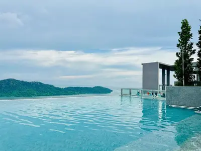 a swimming pool with a view of the water at Explore Penang Stay Style w Sky pool Sea airport 9pax in Bayan Lepas