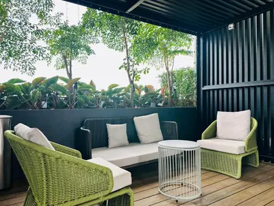 a patio with two chairs and a couch and a table at Sky Pool Luxury Sea View Near Penang Airport 9pax in Bayan Lepas