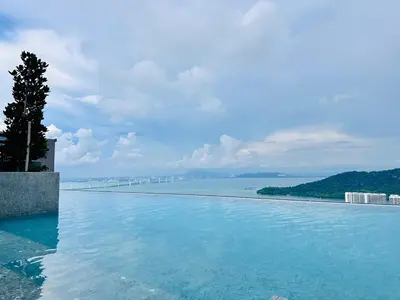 a swimming pool with a view of the ocean at Sky Pool Luxury Sea View Near Penang Airport 9pax in Bayan Lepas