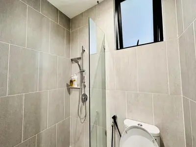 a bathroom with a shower and a toilet and a window at Sky Pool Luxury Sea View Near Penang Airport 9pax in Bayan Lepas