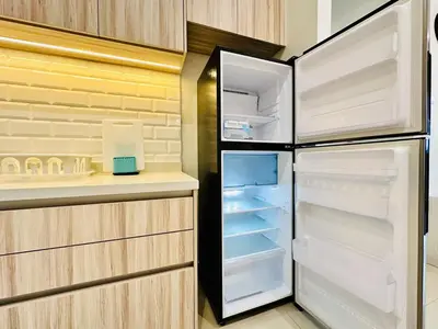 a refrigerator with its door open in a kitchen at Sky Pool Luxury Sea View Near Penang Airport 9pax in Bayan Lepas