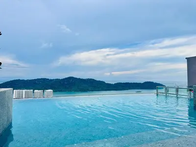 a swimming pool with a view of the ocean at Sky Pool Luxury Sea View Near Penang Airport 9pax in Bayan Lepas