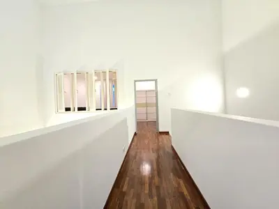 a hallway with white walls and a wooden floor at Shamrock Beach Villas - Batu Ferringhi in Tanjung Bungah