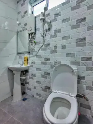 a bathroom with a toilet and a sink at Inapan Tepi Sawah
