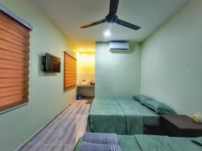 a bedroom with a bed and a ceiling fan at Inapan Tepi Sawah