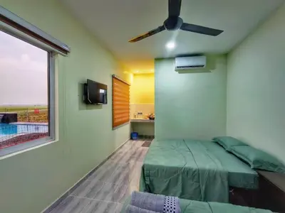 a bedroom with a bed and a ceiling fan at Inapan Tepi Sawah