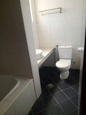 a bathroom with a toilet and a sink and a tub at Marina sunset view in Lumut