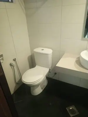 a bathroom with a white toilet and a sink at Marina sunset view in Lumut