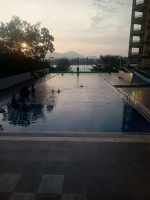 a large pool of water with ducks in it at Marina sunset view in Lumut