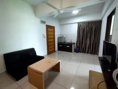 a living room with a couch and a coffee table at Marina sunset view in Lumut