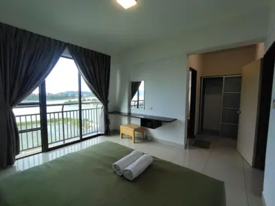 a bedroom with a large bed and a large window at Marina sunset view in Lumut