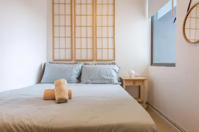 a teddy bear sitting on a bed in a bedroom at Serene Japandi Family Retreat 2-6 pax& Sunrise View in Brinchang