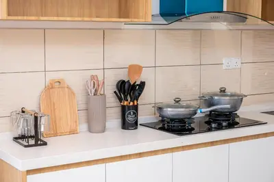 a kitchen counter with two pots and pans on a stove at Serene Japandi Family Retreat 2-6 pax& Sunrise View in Brinchang