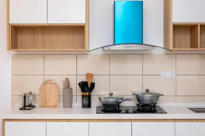 a kitchen counter with two pots and pans on a stove at Serene Japandi Family Retreat 2-6 pax& Sunrise View in Brinchang