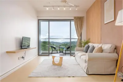 a living room with a couch and a large window at Serene Japandi Family Retreat 2-6 pax& Sunrise View in Brinchang