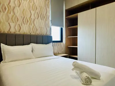 a bedroom with a bed with a towel on it at Premium Comfort Rooftop View bayan lepas airport 9pax in Bayan Lepas