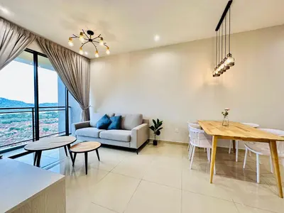a living room with a table and a couch at High Rise Haven 3BR Rooftop Pool Stylish Comfort 9pax in Bayan Lepas