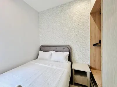 a small bedroom with a bed and a table at High Rise Haven 3BR Rooftop Pool Stylish Comfort 9pax in Bayan Lepas