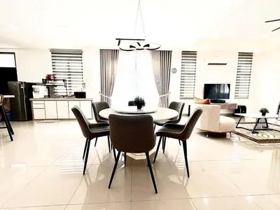 a dining table and chairs in a living room at Gioia Home Two Taiping Town in Taiping