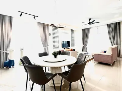 a living room with a white table and chairs at Gioia Home Two Taiping Town in Taiping