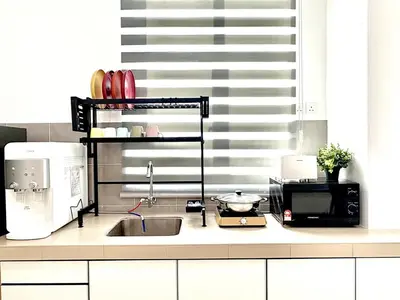 a kitchen counter with a sink and a microwave at Gioia Home Two Taiping Town in Taiping